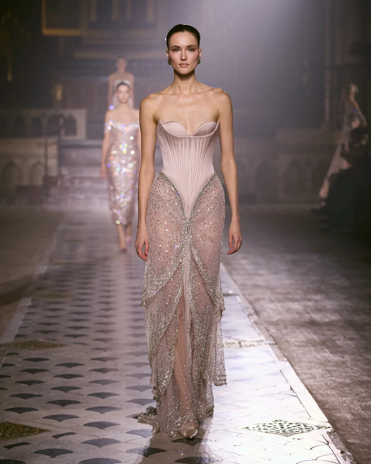 Runway look, a blush sheer beaded corset gown with a sweeping train