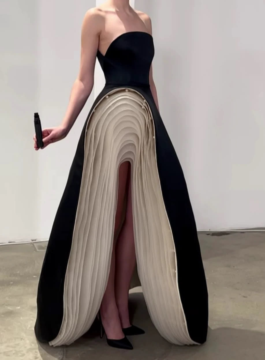 Black strapless gown with a pleated ivory fan skirt